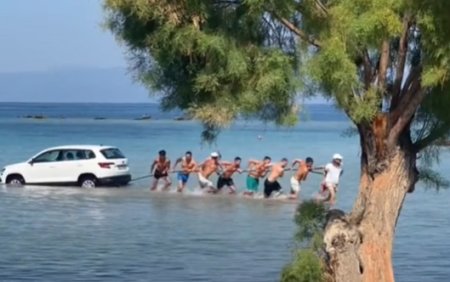 Momentul in care un SUV lasat fara frana de mana trasa cade in mare, in Grecia. Turistii s-au chinuit sa salveze masina