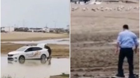 Imagini demne de cascadorii rasului | Doi politisti din Constanta au ramas cu masina impotmolita pe plaja: Si-a bagat picioarele in saci de gunoi